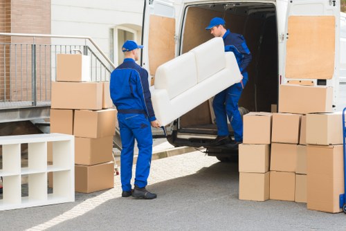 Professional office moving team handling equipment during Denmarkhill removals
