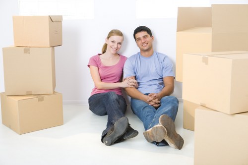 Moving team handling flat removals in Denmarkhill outside an apartment building